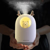a woman holding the baby humidifier