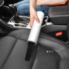 handheld vacuum cleaner being used in the car