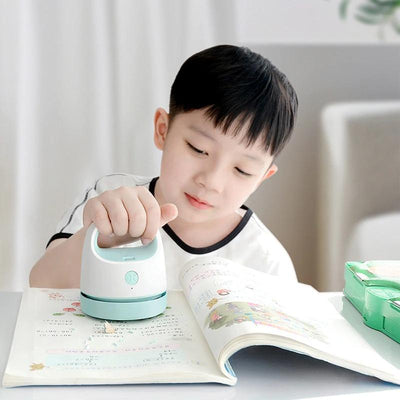a kid using the vacuum cleaner
