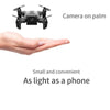 Mini drone flying above a person's palm