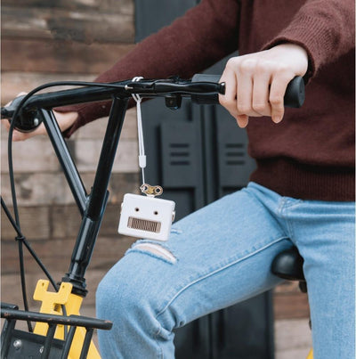 mini bluetooth speaker being tied to a bicycle