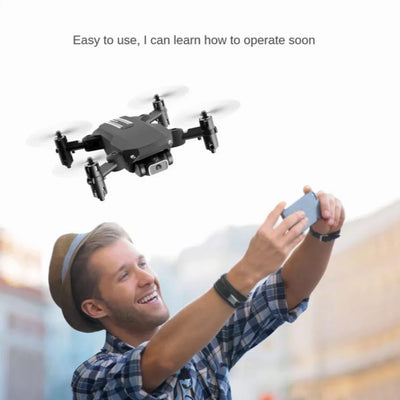 a man flying the mini drone