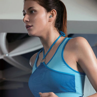 A girl wearing Motorola earphones in gym