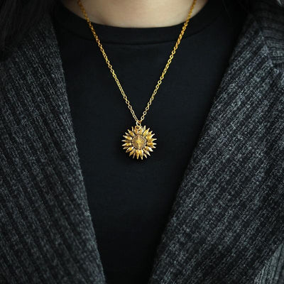 a woman wearing the sunflower necklace